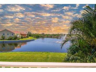 Scenic water view featuring a fountain, lush greenery, and glimpses of nearby homes under a partly cloudy sky at 17 Franklin S Ct # C, St Petersburg, FL 33711