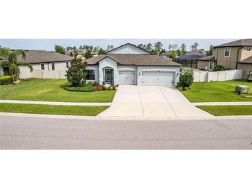 Charming single-story home with a well-maintained lawn and spacious driveway leading to a two-car garage at 18827 Henequen Lane, Spring Hill, FL 34610