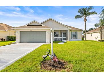 Charming single-story home with a well-maintained lawn, lovely landscaping, and a two-car garage at 2227 North Creek Ct, Sun City Center, FL 33573