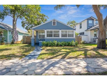 Charming blue bungalow with manicured lawn and a welcoming front porch at 2720 14Th N Ave, St Petersburg, FL 33713