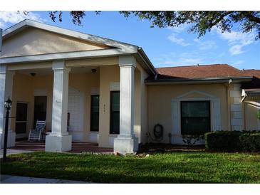 Charming single-story home featuring a well-maintained lawn and a welcoming, column-supported entryway at 311 Kelsey Way # 3, Sun City Center, FL 33573