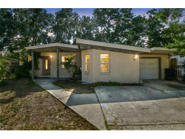 Inviting single-story home featuring a unique roofline, covered entry, and driveway at 4412 Bray Rd, Tampa, FL 33634