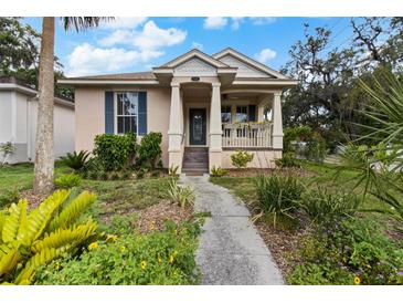 Charming single-story home with a covered porch and lush landscaping at 502 Lincoln Ave, Tarpon Springs, FL 34689