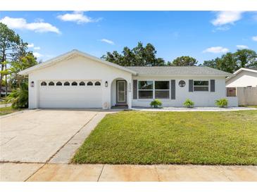 Charming single-story home featuring a well-manicured lawn, attached garage, and white exterior at 6006 114Th N Ter, Pinellas Park, FL 33782