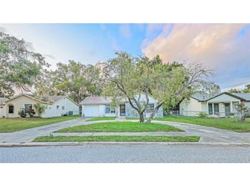 Charming one-story home features a circular driveway and unique stone accents at 7033 Wentworth Way, New Port Richey, FL 34655