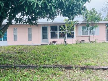 Charming house with a well-maintained front yard and mature landscaping at 72 Lake Shore Dr, Palm Harbor, FL 34684