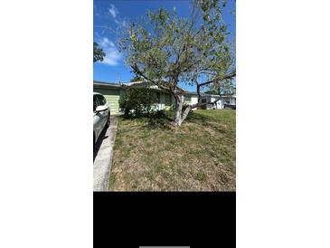 Charming single-story home with a well-manicured front yard at 10029 Brunswick Ln, Port Richey, FL 34668