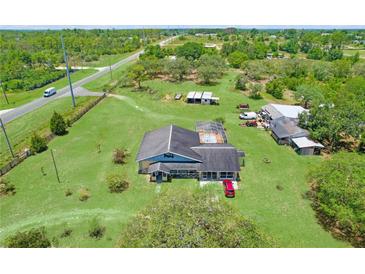 Expansive property with a pool, outbuildings, and a well-maintained lawn at 13341 Hexam Rd, Weeki Wachee, FL 34613