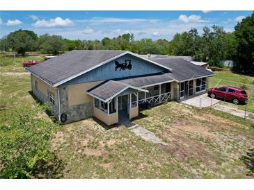 A charming single-story home with stucco and stone accents, complete with a screened-in porch at 13341 Hexam Rd, Weeki Wachee, FL 34613