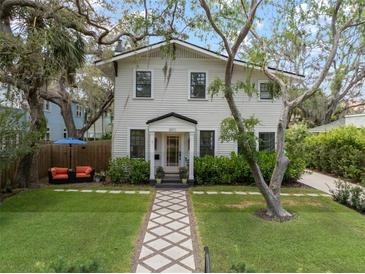 Charming two-story home with inviting walkway, lush landscaping, and well-manicured front yard at 3011 Harbor View, Tampa, FL 33611