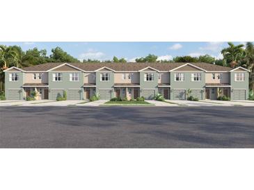 Charming townhomes featuring two-story construction, individual garages, and professionally landscaped front yards at 4414 Rachel Falls Dr, Tampa, FL 33610