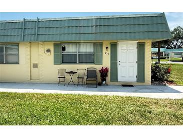Charming condo with green shutters, front door, and room for seating to enjoy the outdoors at 102 Cambridge Trl # 230, Sun City Center, FL 33573