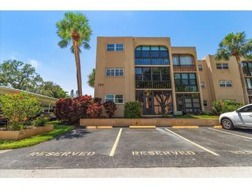Lovely condo exterior featuring reserved parking, mature landscaping, and architectural design elements at 11485 Oakhurst Rd # 200-101, Largo, FL 33774