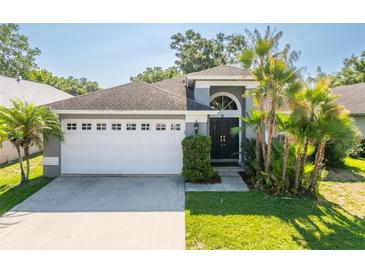 Charming single Gathering home featuring a gray exterior, well-manicured lawn, and a two-car garage at 2024 Glen Forge St, Brandon, FL 33511