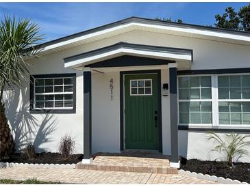 Inviting front door with a green painted finish and a charming, covered entryway at 4511 Hampshire Rd, Tampa, FL 33634