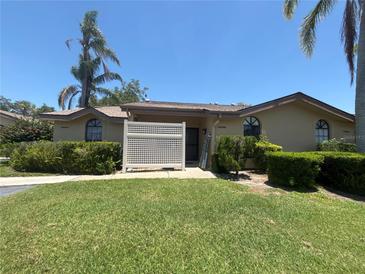 Inviting one-story home featuring lush landscaping and a well-manicured lawn on a sunny day at 4558 Morningside # 43, Sarasota, FL 34235