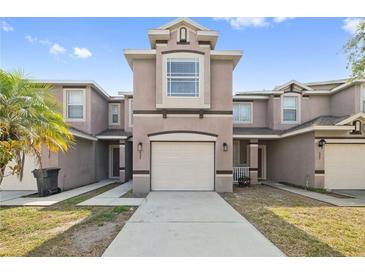 Inviting townhome featuring a two-car garage and neutral color scheme at 527 Glenn Cross Dr, Ruskin, FL 33570