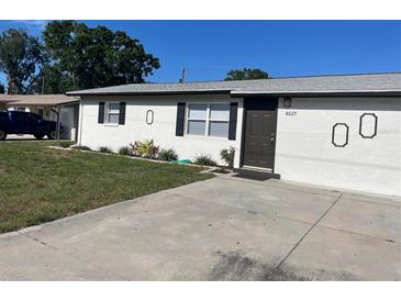 Charming single-story home featuring a well-maintained lawn and a concrete driveway at 8665 55Th N St, Pinellas Park, FL 33782