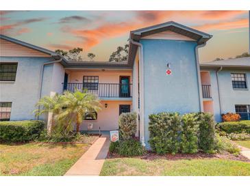 Charming two-story condo with vibrant landscaping and a welcoming entrance at 11800 Park Blvd # 208, Seminole, FL 33772