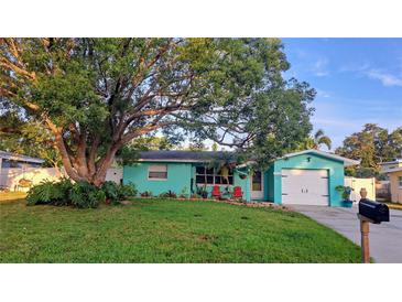 Charming home featuring vibrant curb appeal, complemented by lush landscaping and a welcoming driveway at 12176 Croft Dr, Largo, FL 33774
