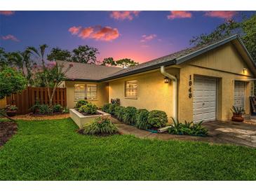 Charming single Gathering home with manicured landscaping and a one car garage at 1948 Elaine Dr, Clearwater, FL 33760