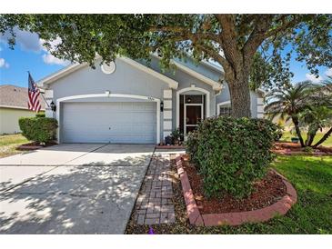 Charming single-story home with mature landscaping, inviting curb appeal, and an attached two-car garage at 5925 Sweet William Ter, Land O Lakes, FL 34639