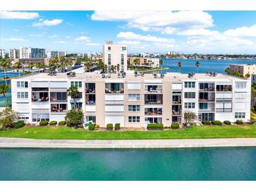 Multi-story condo building featuring waterfront views, private balconies, and well-maintained landscaping at 7625 Sun Island S Dr # 304, South Pasadena, FL 33707