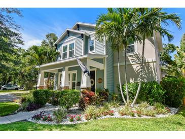 Charming two-story home featuring inviting front porch, lush landscaping, and beautiful curb appeal at 925 Monticello N Blvd, St Petersburg, FL 33703