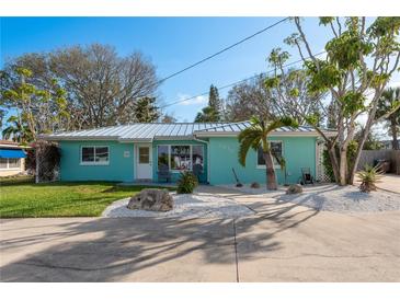 Charming home with a metal roof, delightful landscaping, and a welcoming front entrance at 2010 Bayview Pl, Indian Rocks Beach, FL 33785