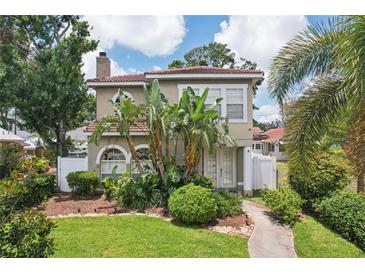 Charming home with beautiful landscaping, tropical plants, and a lovely walkway at 2616 11Th N St, St Petersburg, FL 33704