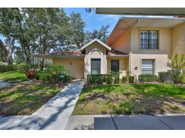 Charming single-story home with well-maintained landscaping and inviting walkway at 311 Knottwood Ct, Sun City Center, FL 33573