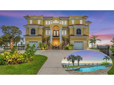 Stunning multi-story home showcasing unique architectural details, pristine landscaping, and a private pool with water views at 3236 Gulf Winds Cir, Hernando Beach, FL 34607