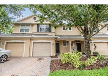 Charming townhome with a well-maintained brick driveway and lush landscaping at 3922 Silverlake Way, Wesley Chapel, FL 33544