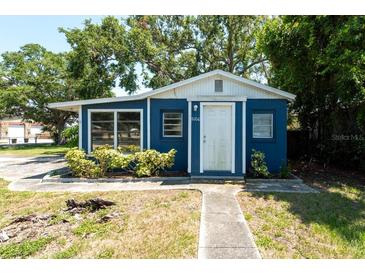 Charming single story home featuring a blue exterior with well-maintained landscaping and mature trees at 5106 15Th S Ave, Gulfport, FL 33707