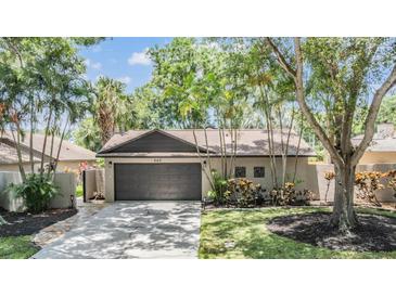 Charming single-story home with a well-manicured lawn and mature landscaping, featuring a two-car garage at 660 Channing Dr, Palm Harbor, FL 34684