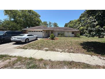 Charming one-story home with a two-car garage and mature landscaping in a suburban setting at 7700 Willow Brook Ct, Hudson, FL 34667