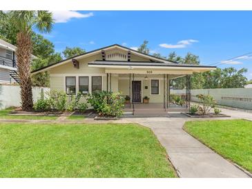 Charming single-story home features a well-manicured lawn and lovely landscaping at 909 E 15Th Ave, Tampa, FL 33605