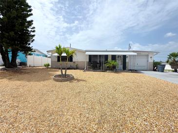 Charming single-story home with a well-maintained shell yard and attractive landscaping at 4902 Panorama Ave, Holiday, FL 34690