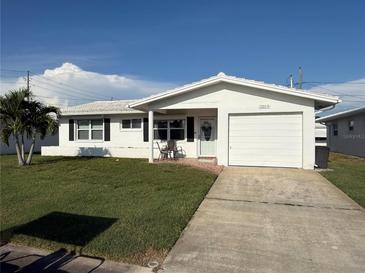 Charming single-story home featuring a garage, well-maintained lawn, and appealing curb appeal at 10169 45Th N St, Pinellas Park, FL 33782