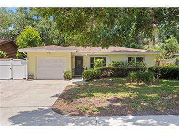 Charming single-story home with a well-maintained front yard, a garage, and a welcoming entrance at 2136 Cunningham Dr, Clearwater, FL 33763