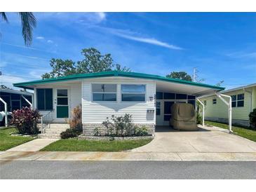 Charming mobile home with covered parking and a well-maintained front yard at 34041 Azalea N Dr, Pinellas Park, FL 33781