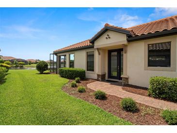 Charming single-story home with a red tile roof, manicured lawn, and inviting front entrance at 11354 Callisia Dr, Odessa, FL 33556