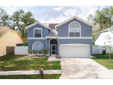 Charming two-story home with a well-maintained lawn and an attached two-car garage at 2318 Kenwick Dr, Valrico, FL 33596