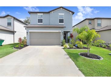 Charming two-story home with a well-manicured lawn and inviting curb appeal and a two car garage at 36312 Garden Wall Way, Zephyrhills, FL 33541