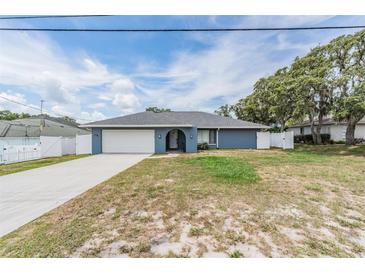 Charming single-story home with a well-maintained lawn and attached garage at 5540 Applegate Dr, Spring Hill, FL 34606
