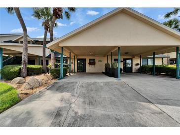Inviting covered front entrance with lush landscaping and well-maintained carport in a desirable community at 644 Yardarm Dr # 22, Apollo Beach, FL 33572
