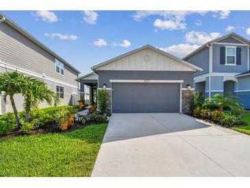 Charming single Gathering home with a well-maintained lawn and beautiful landscaping at 9577 Sandy Bluffs Cir, Parrish, FL 34219