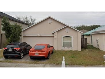 Charming single-story home features a two-car garage and a well-maintained front yard at 11334 Ivy Flower Loop, Riverview, FL 33578