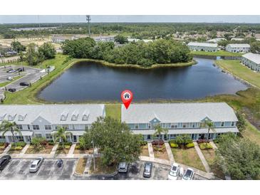 Beautiful waterfront townhomes with lush landscaping and ample parking spaces at 11617 Colony Lake Dr, Tampa, FL 33635