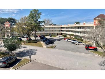 Three-story condominium building with ample parking and lush landscaping at 2262 Swedish Dr # 6, Clearwater, FL 33763